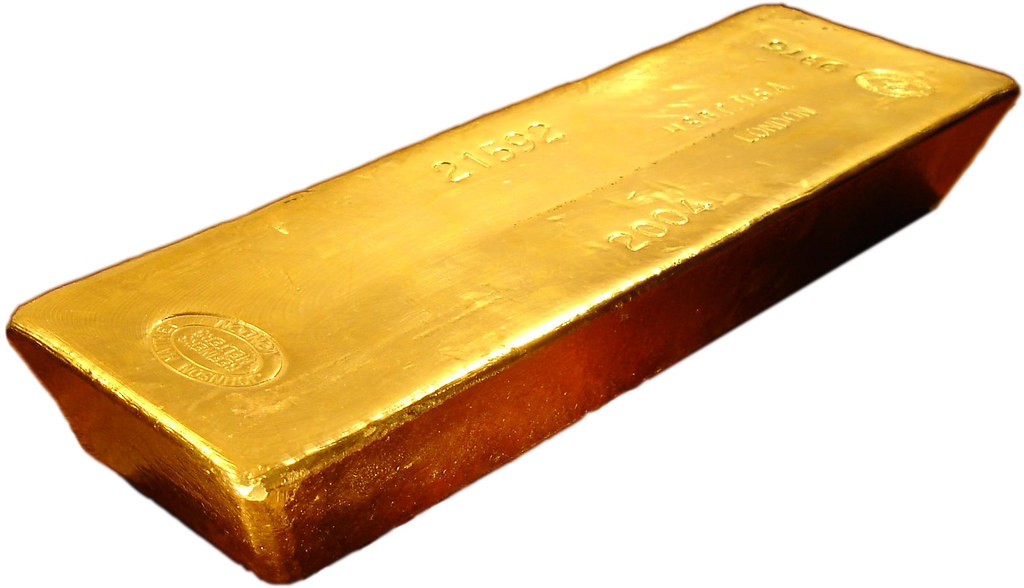 Lingots d'or empilés symbolisant l'or physique adossé au jeton tokenisé XAU₮ de Tether